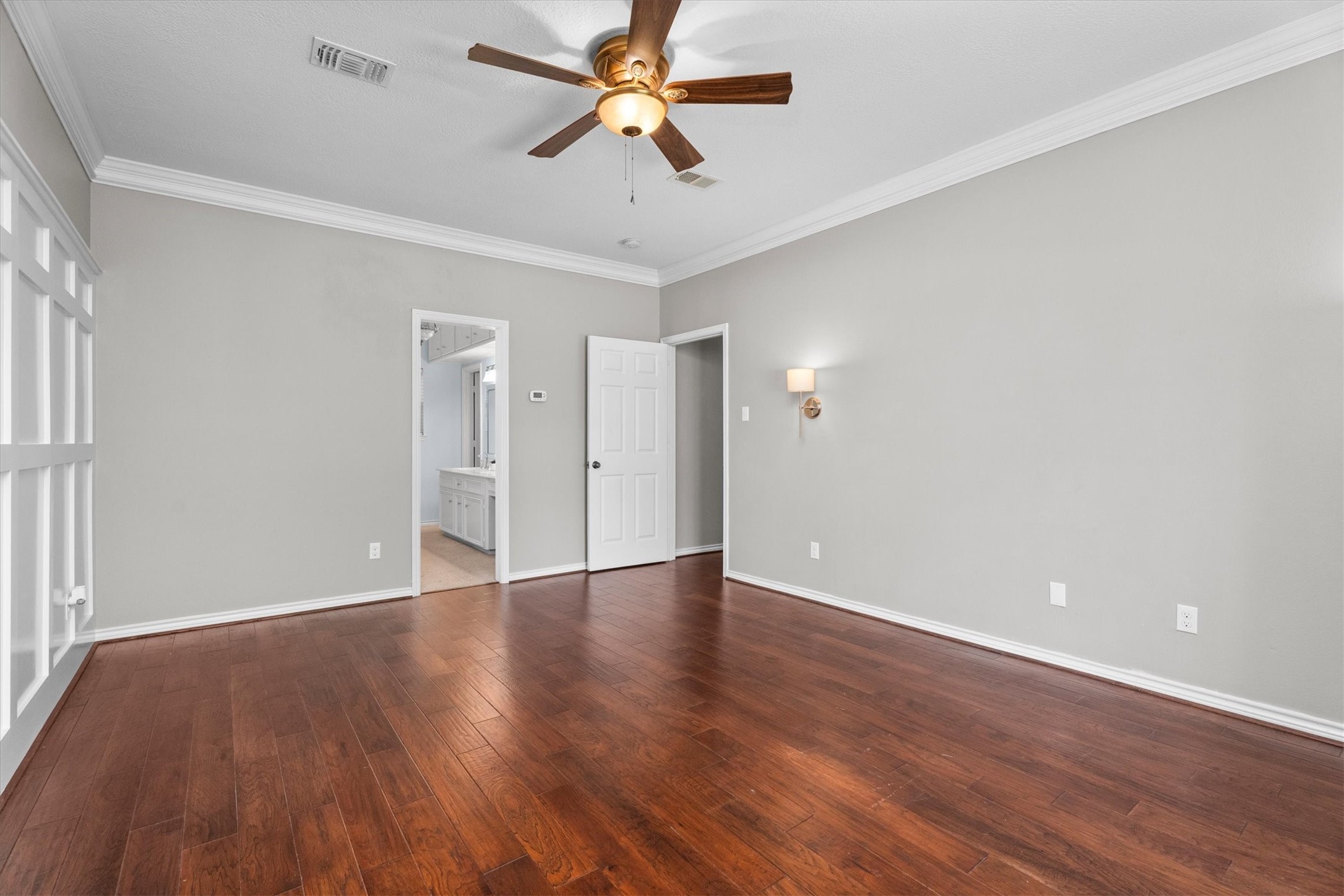 16267 Salmon Lane Spring, TX 77379 - Photo 24 of 48 Wall sconces add additional detail and charm to the primary bedroom. Wood flooring continues throughout.