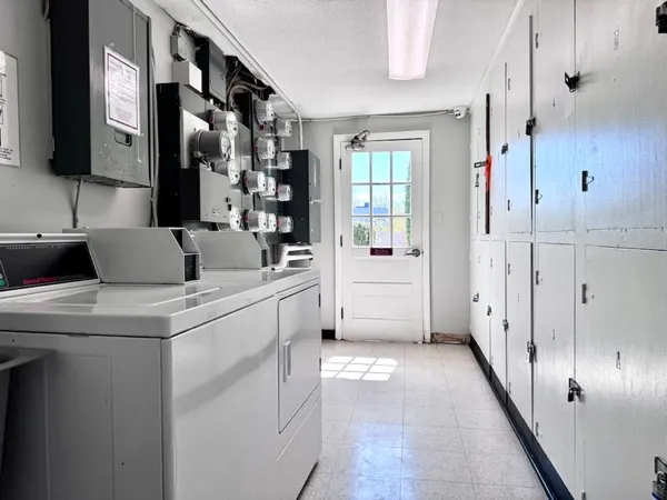 a kitchen with white cabinets and white appliances