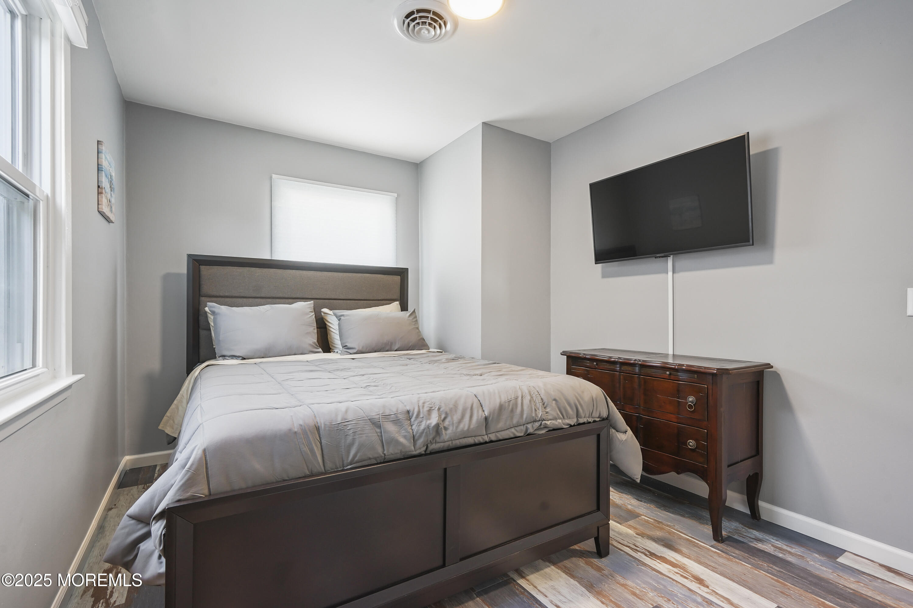 214 Webster Avenue, Unit 2 Seaside Heights, NJ 08751 - Photo 11 of 14 a bedroom with a bed and a flat screen tv