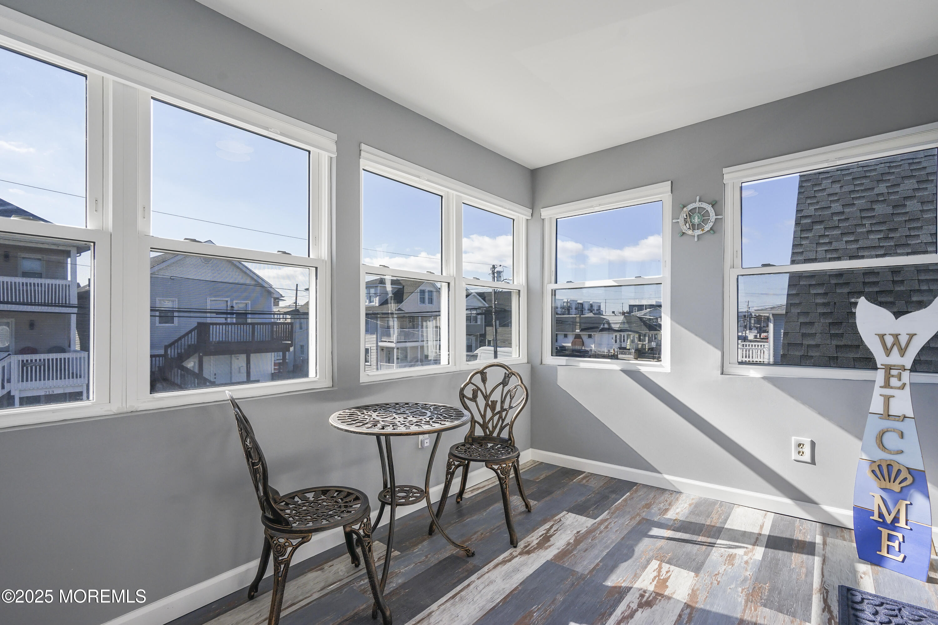 214 Webster Avenue, Unit 2 Seaside Heights, NJ 08751 - Photo 14 of 14 a view of a dining room with furniture large windows and wooden floor