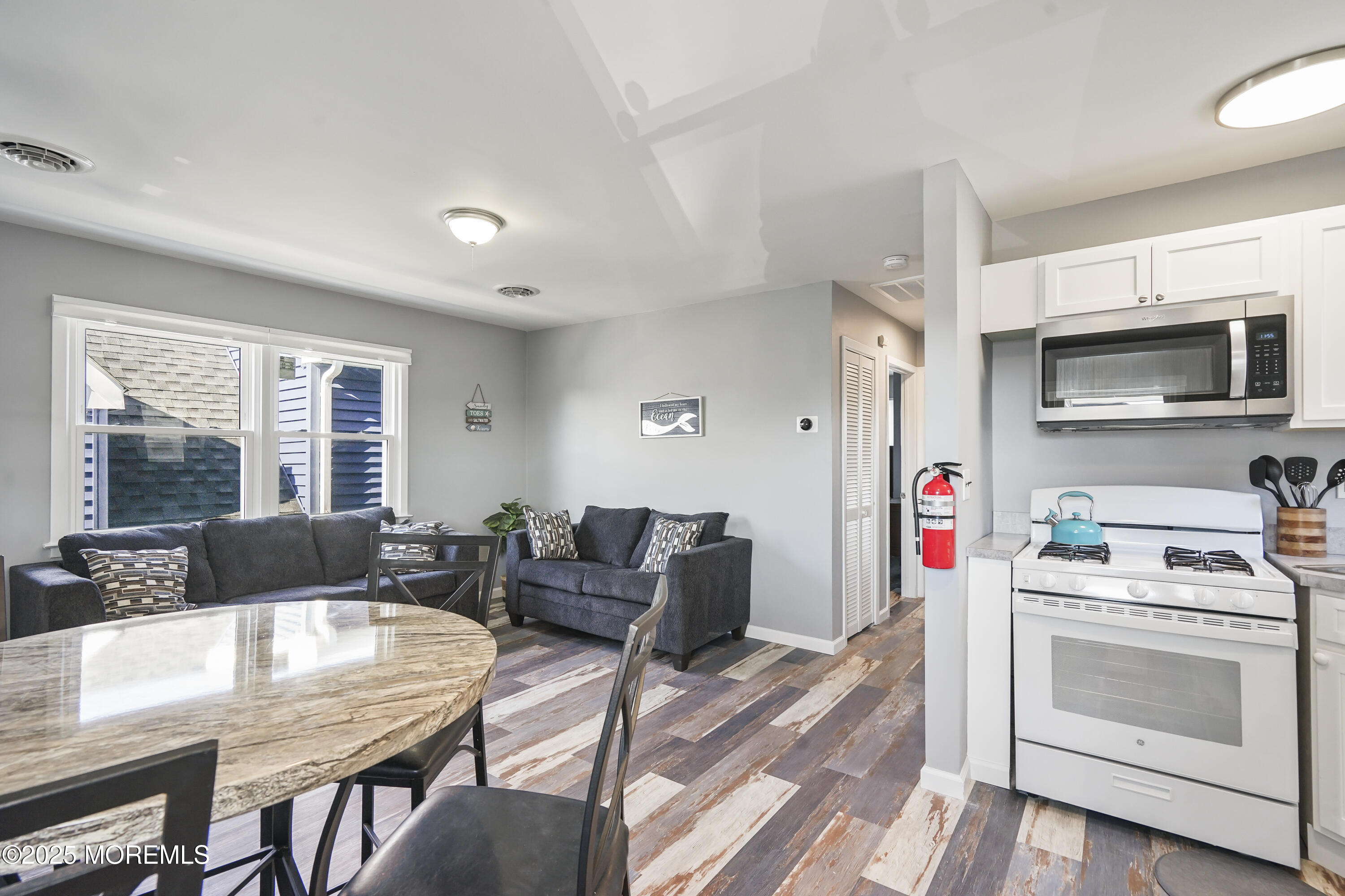 214 Webster Avenue, Unit 2 Seaside Heights, NJ 08751 - Photo 4 of 14 a living room with furniture and a flat screen tv