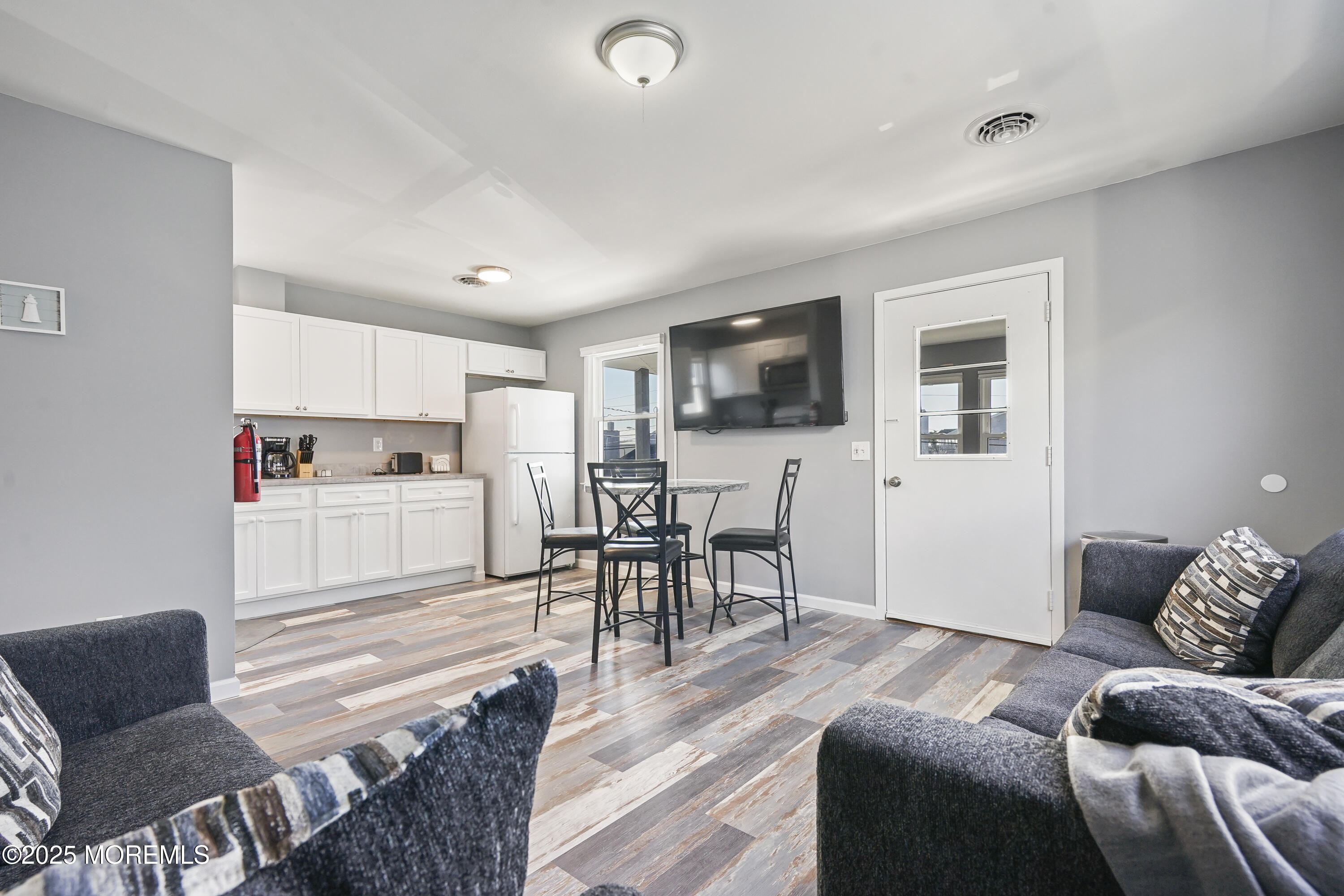 214 Webster Avenue, Unit 2 Seaside Heights, NJ 08751 - Photo 6 of 14 a living room with furniture and a flat screen tv