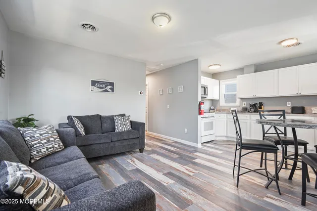 a living room with furniture and kitchen view