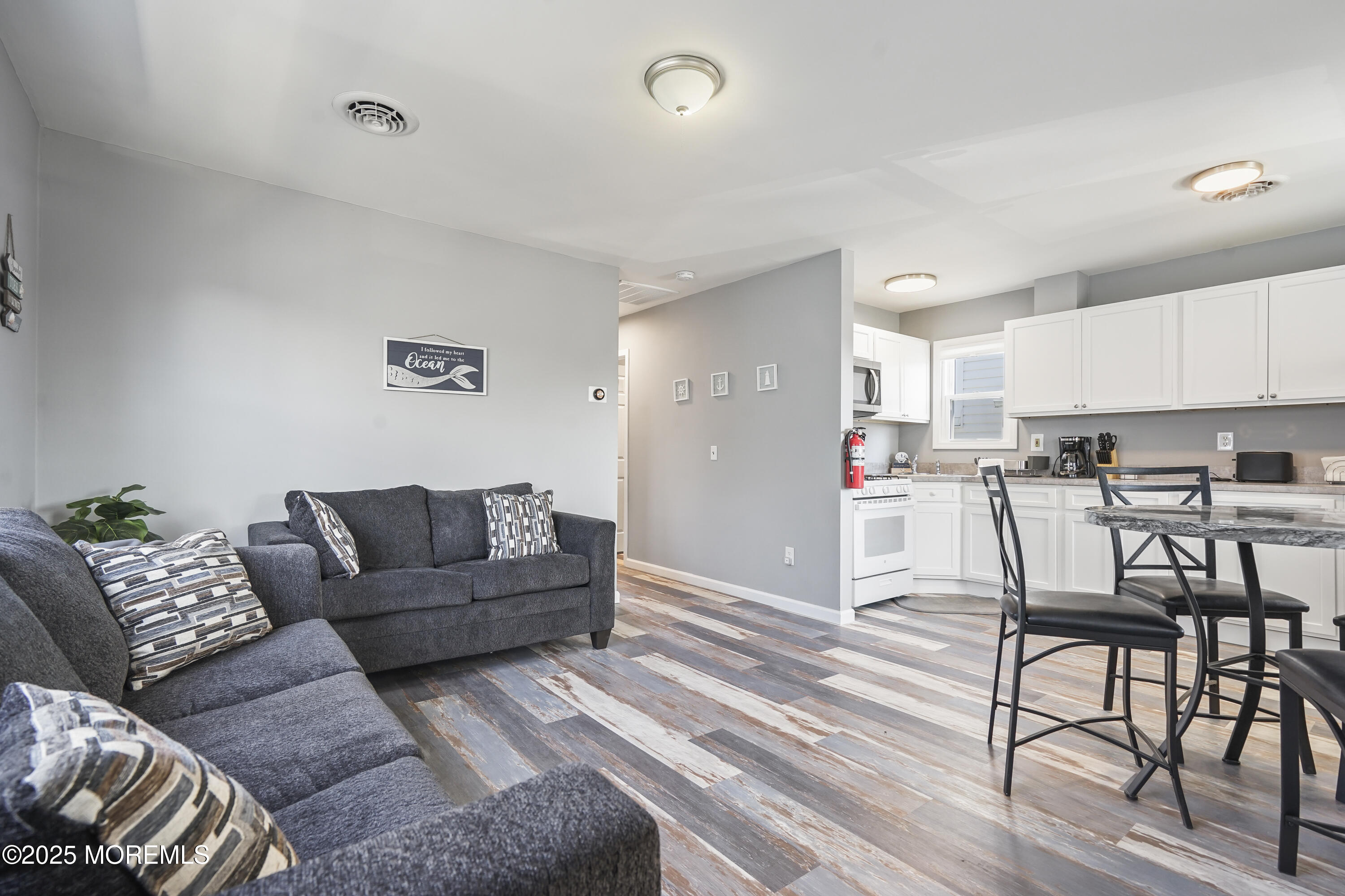 214 Webster Avenue, Unit 2 Seaside Heights, NJ 08751 - Photo 7 of 14 a living room with furniture and kitchen view