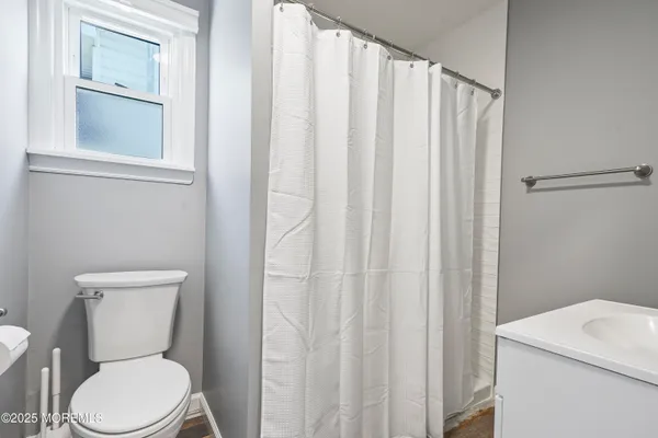 a white toilet sitting next to a white sink