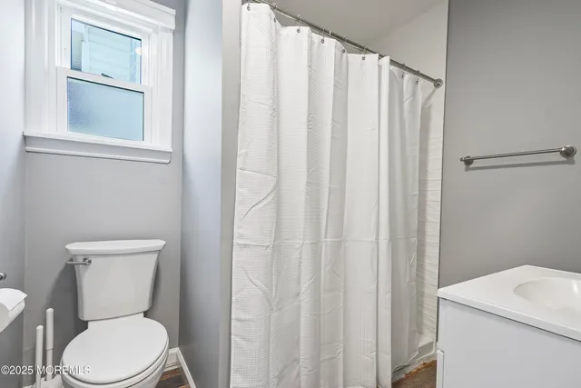 a white toilet sitting next to a white sink