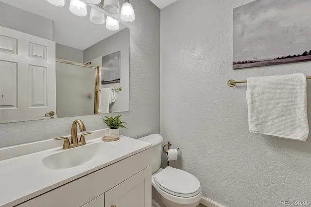 a bathroom with a sink toilet a mirror and shower