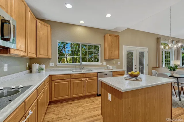 a kitchen with a sink cabinets and window
