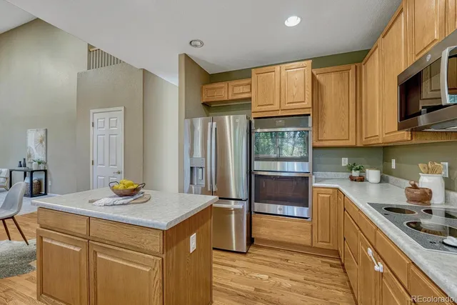 a kitchen with granite countertop a sink stove and refrigerator