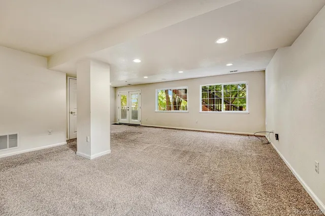 an empty room with windows and entrance