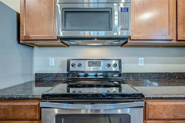 a stove top oven sitting inside of a kitchen