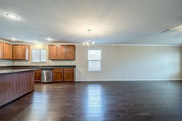 a large kitchen with hard wood floors and wooden floors