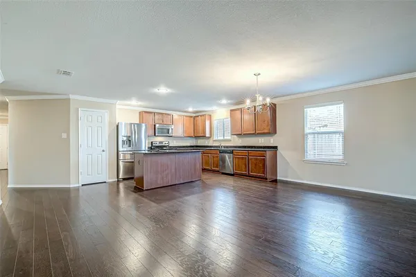 a view of kitchen with sink and wooden floor