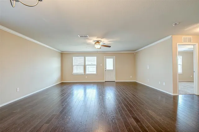 wooden floor in an empty room with a window