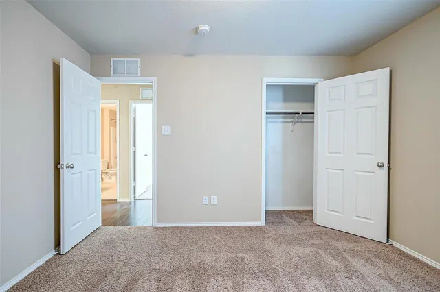 a view of a kitchen with refrigerator and wooden floor