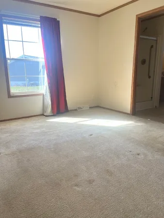 an empty room with windows and closet