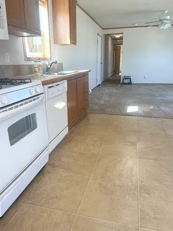 a kitchen with a stove a sink and a refrigerator