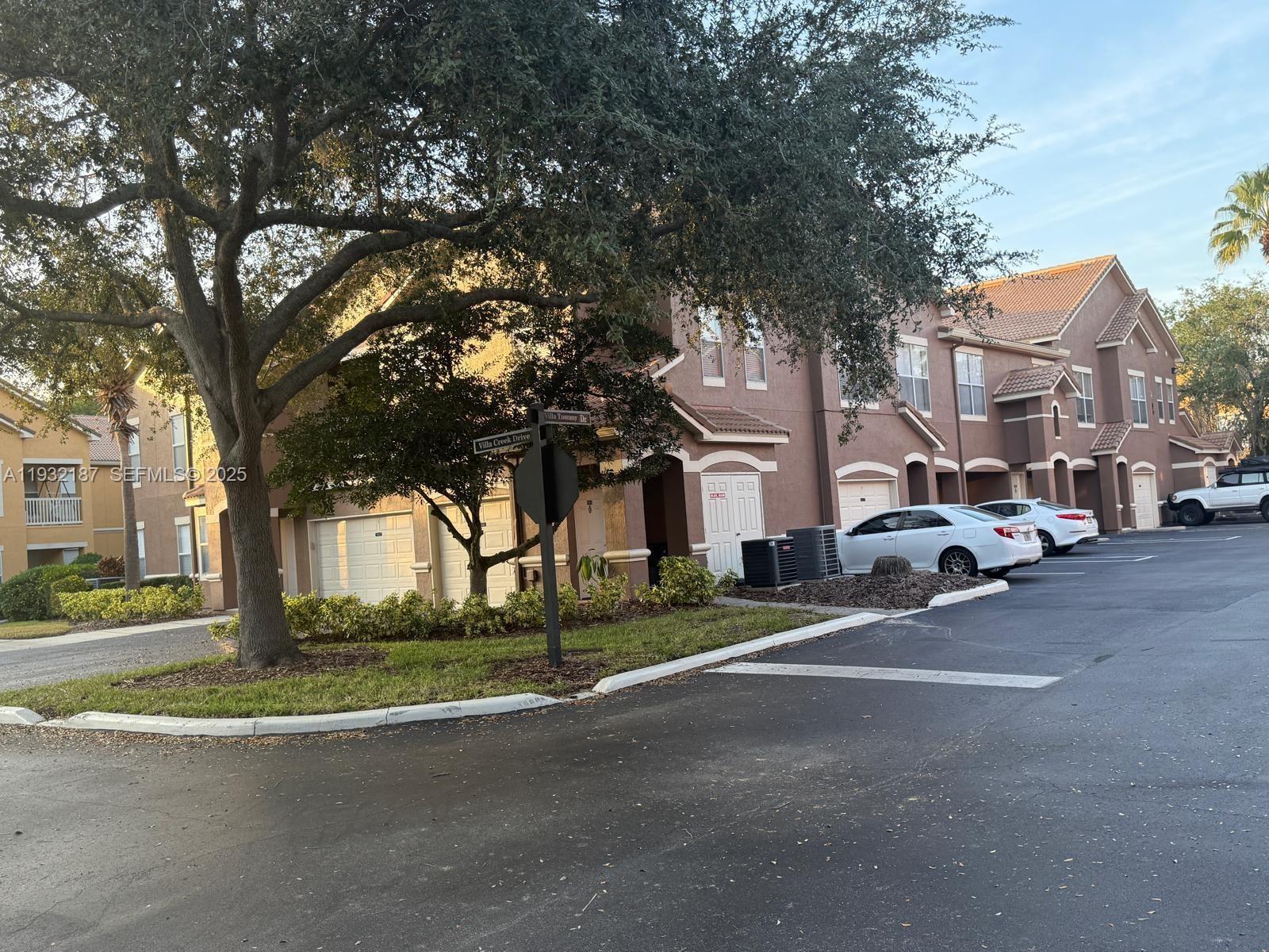 19914 Villa Creek Drive, Unit 202 Orlando, FL 32821 - Photo 18 of 19 a view of a street with houses on the side
