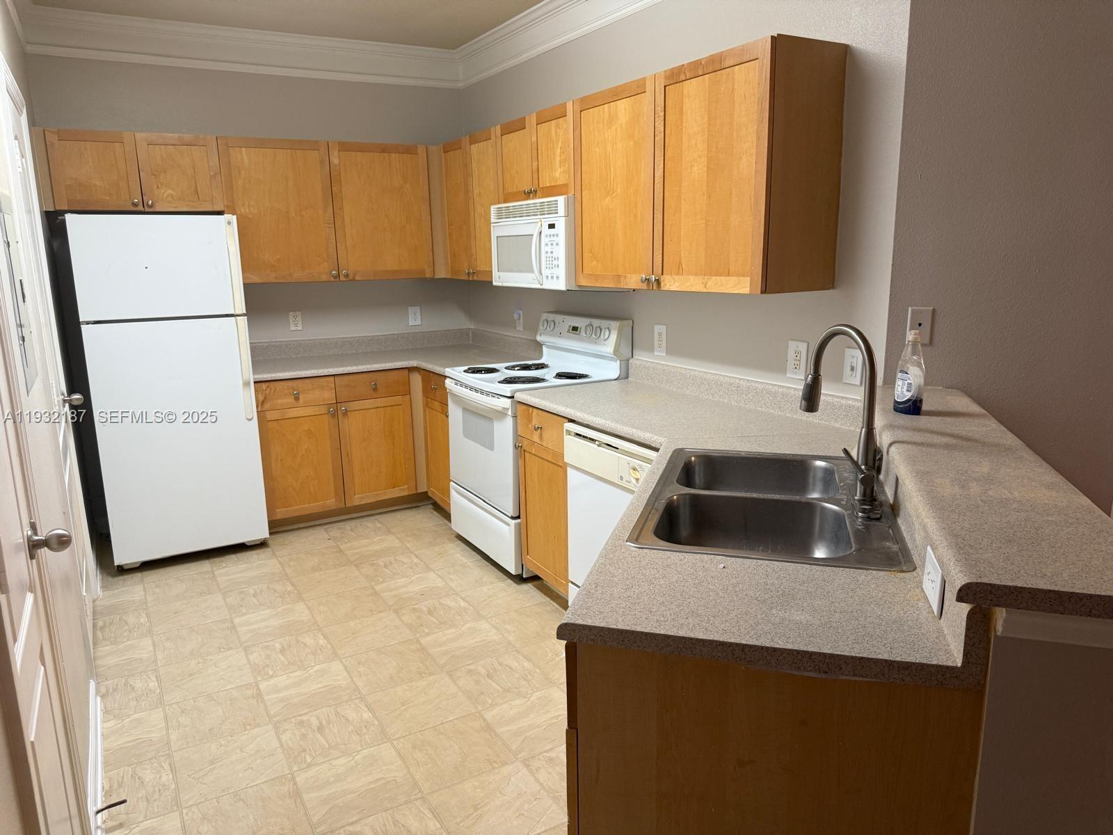 19914 Villa Creek Drive, Unit 202 Orlando, FL 32821 - Photo 2 of 19 a kitchen with stainless steel appliances granite countertop a sink a refrigerator and a stove