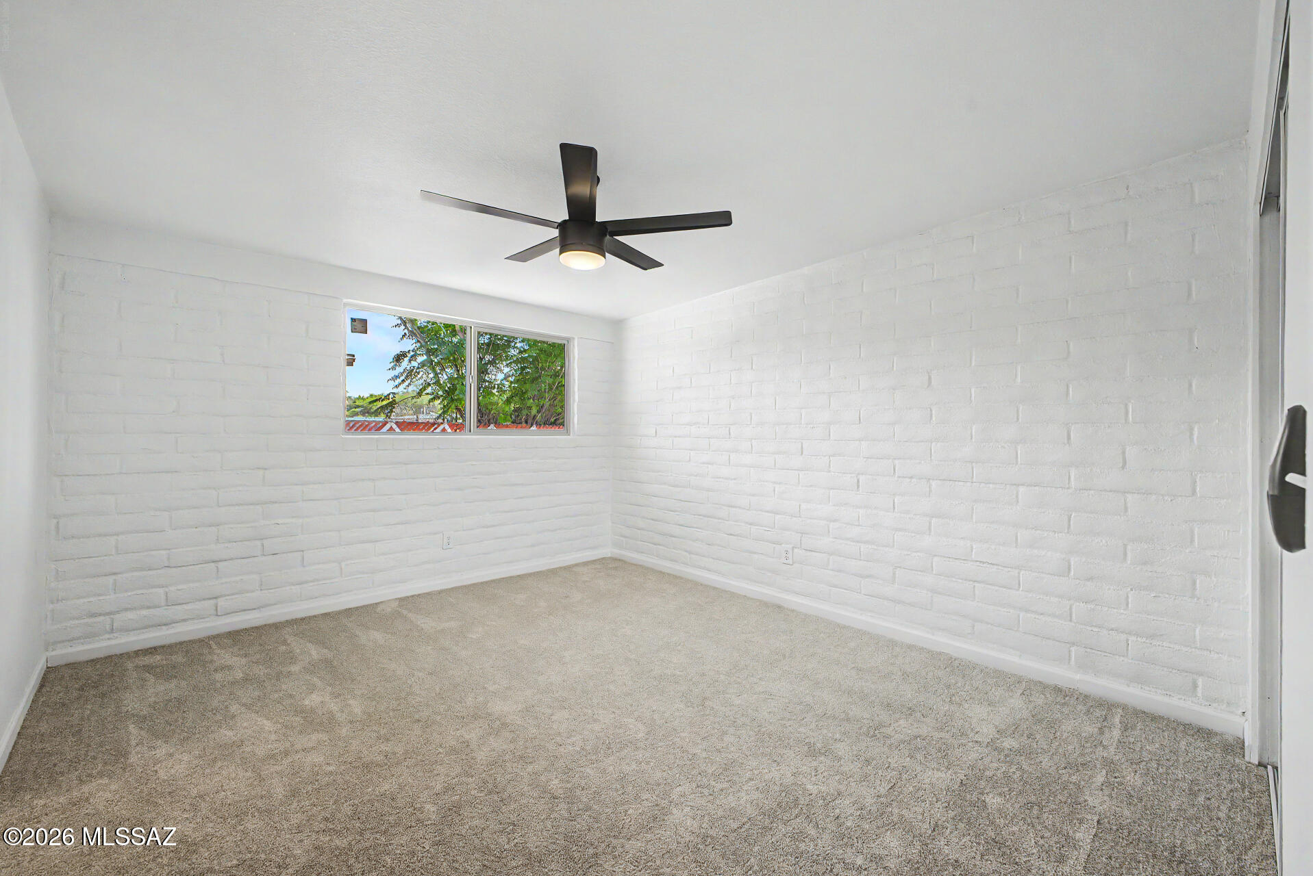 3402 South Kolb Road Tucson, AZ 85730 - Photo 11 of 32 en empty room with windows and ceiling fan