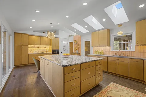 a dining room with furniture and a floor to ceiling window