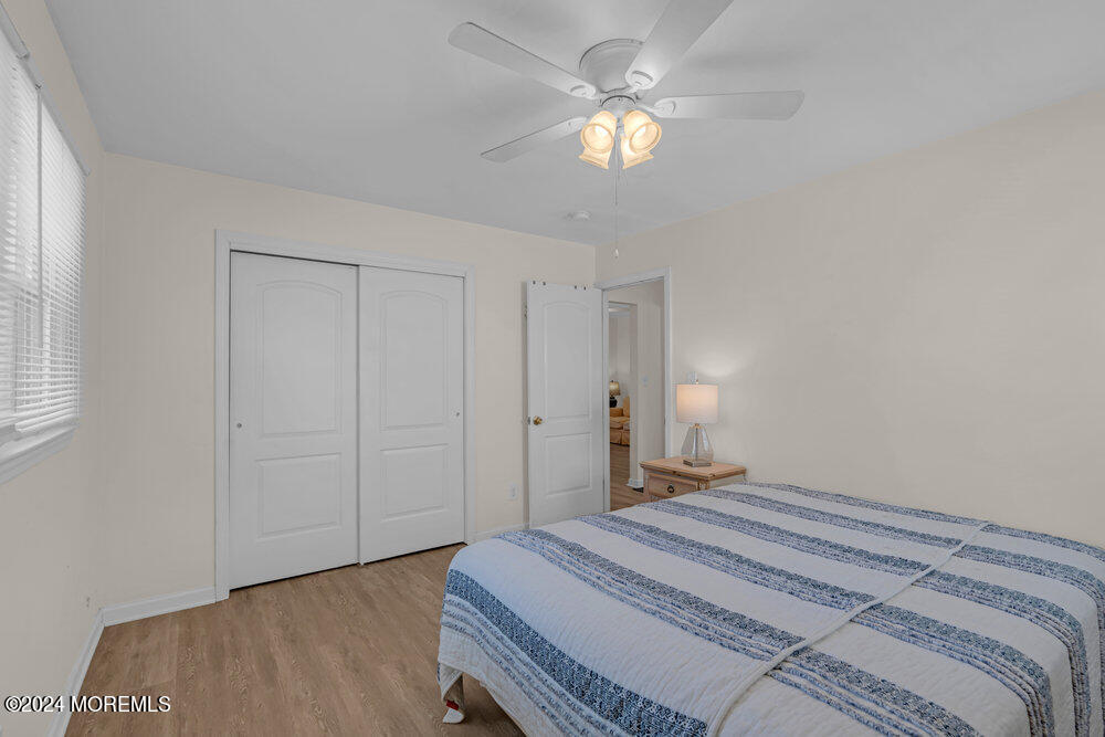 137 Marcellus Avenue Manasquan, NJ 08736 - Photo 15 of 17 a bedroom with a bed and a chandelier