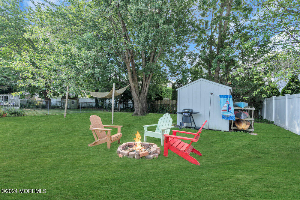 137 Marcellus Avenue Manasquan, NJ 08736 - Photo 16 of 17 a view of backyard with wooden fence and large trees
