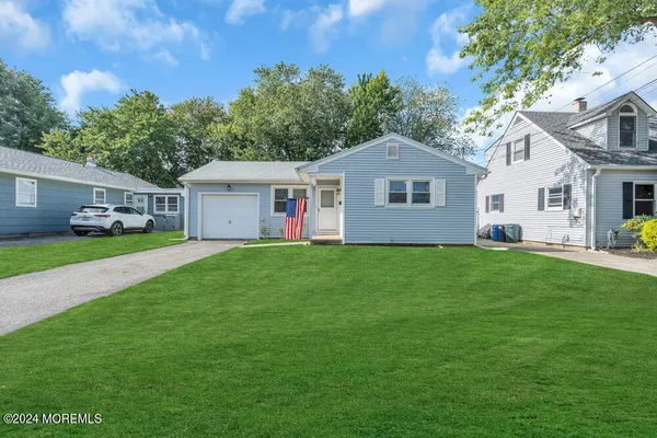 a front view of house with yard and green space