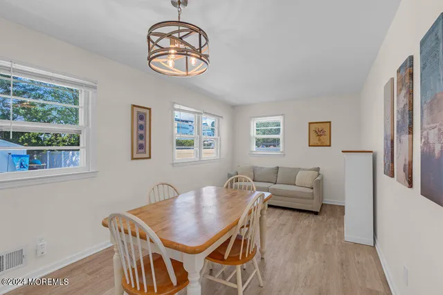 a view of a livingroom with furniture window and wooden floor