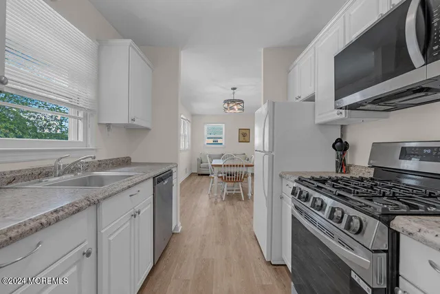 a kitchen with stainless steel appliances granite countertop a stove and a sink