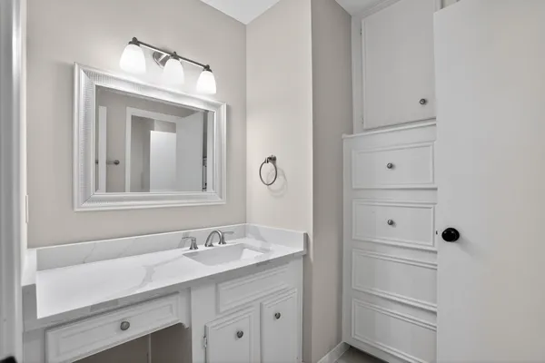 a bathroom with a granite countertop sink and a mirror