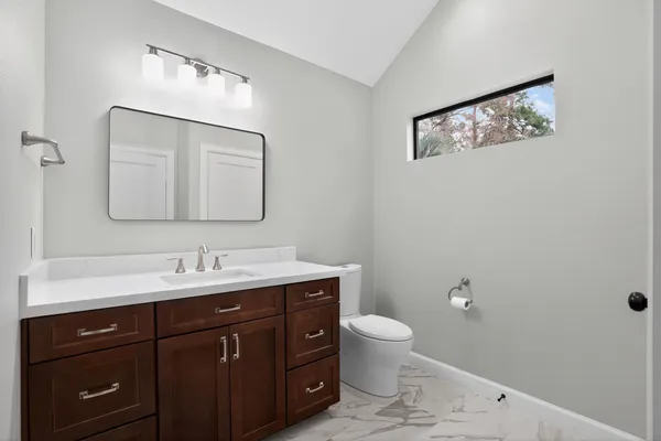 a bathroom with a double vanity sink mirror and shower