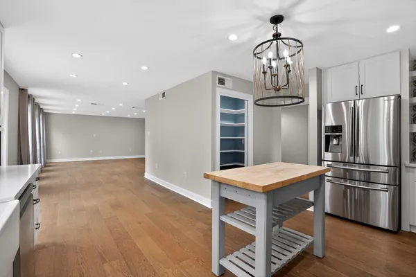 a kitchen with stainless steel appliances granite countertop a stove refrigerator and a sink