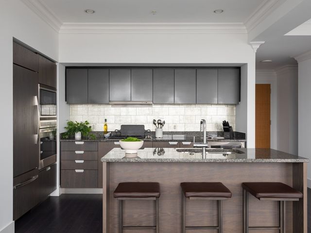 a kitchen with stainless steel appliances a stove a sink and a microwave