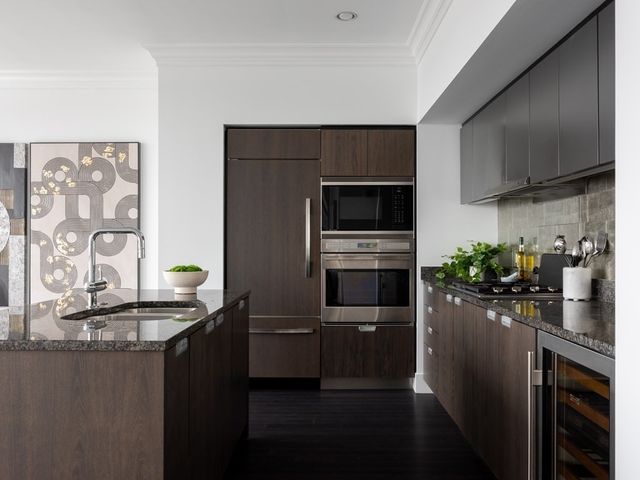 a bathroom with a sink a potted plant and mirror