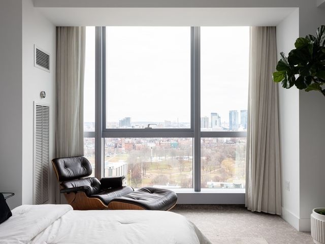 a large bed sitting in a bedroom and lamp