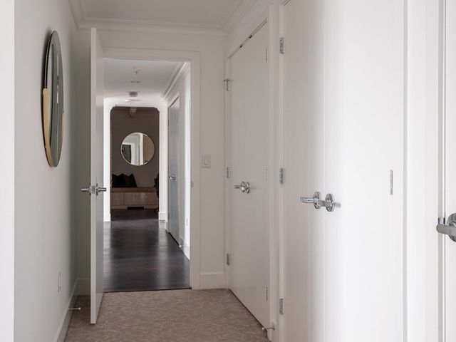 a view of walk in closet with cabinet and gate