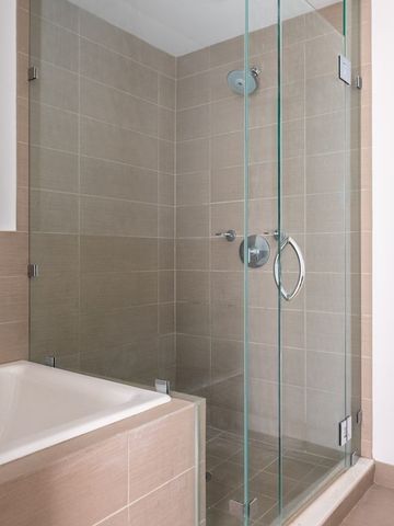 a bedroom with a large bed and a large window with outer view