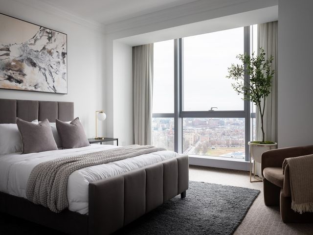 a bedroom with a bed and a night stand