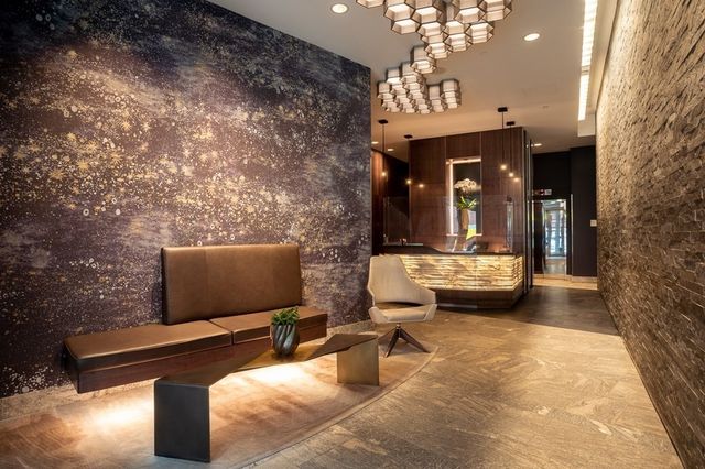 a lobby with furniture and floor to ceiling window