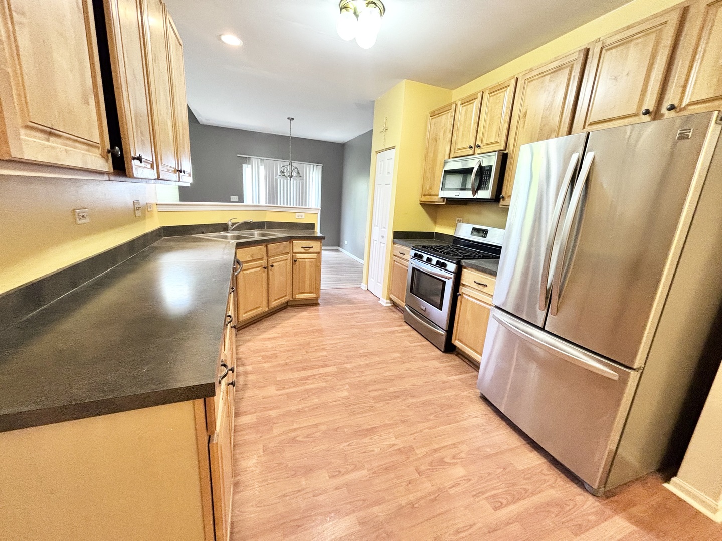 2428 Reflections Drive Aurora, IL 60502 - Photo 3 of 15 a kitchen with stainless steel appliances granite countertop a refrigerator a stove and a sink
