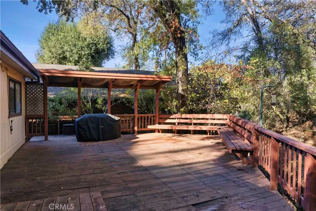 a view of backyard with deck and wooden floor