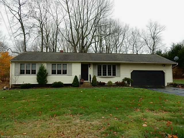 a view of a house with a yard and sitting area