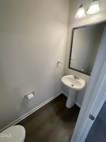 a bathroom with a sink toilet and a mirror