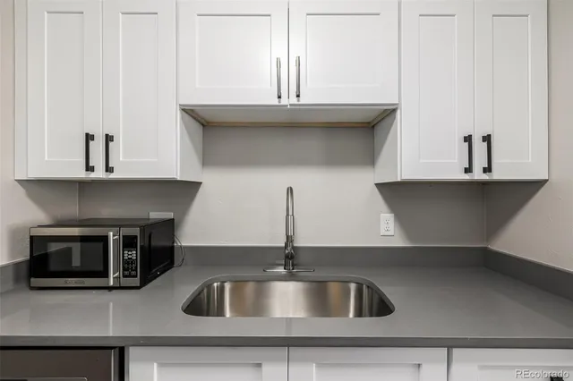 a kitchen with a sink and cabinets