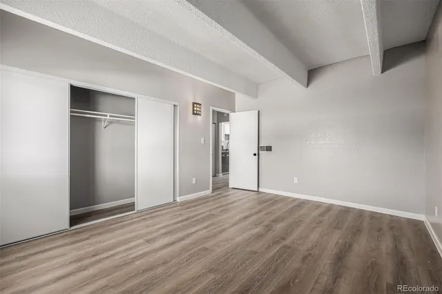 a view of an empty room with wooden floor