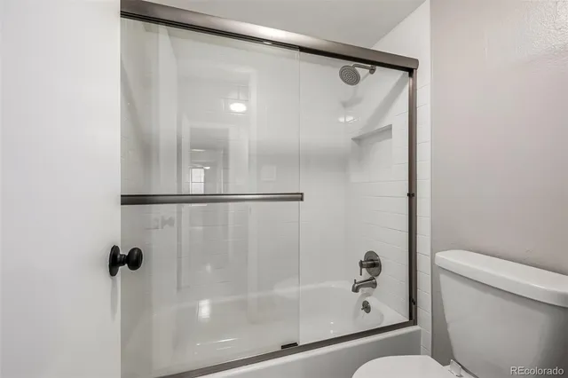 a bathroom with a shower and a toilet