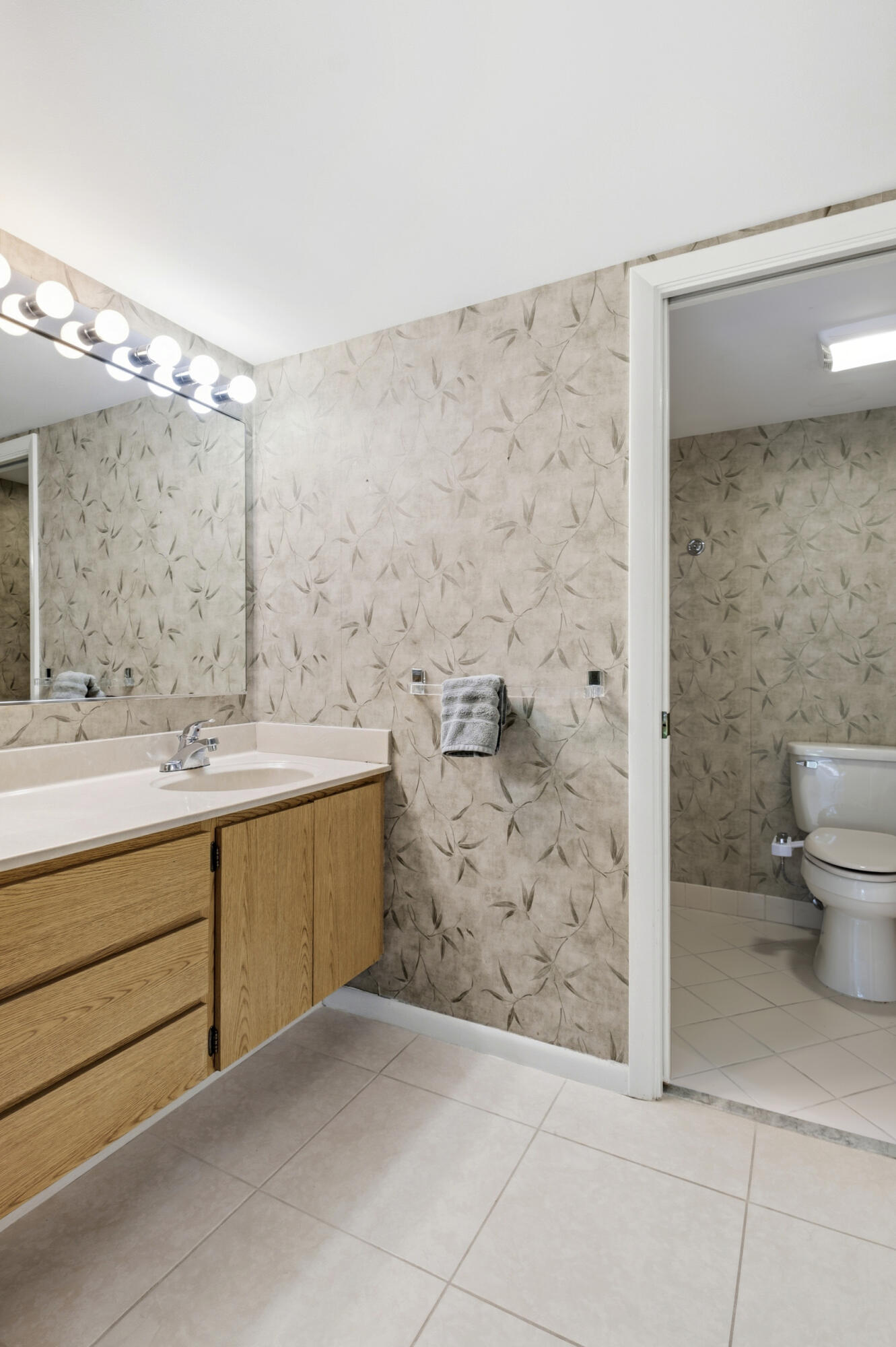 6145 Balboa Circle, Unit 103 Boca Raton, FL 33433 - Photo 15 of 31 a bathroom with a sink a toilet and shower
