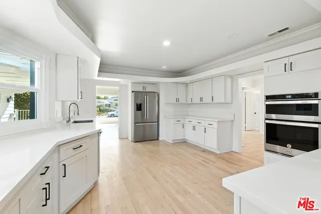a view of washer and dryer with kitchen in the background