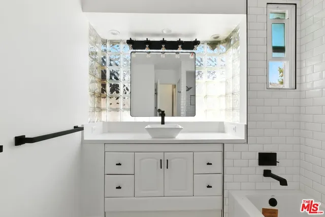 a bathroom with a bathtub and shower